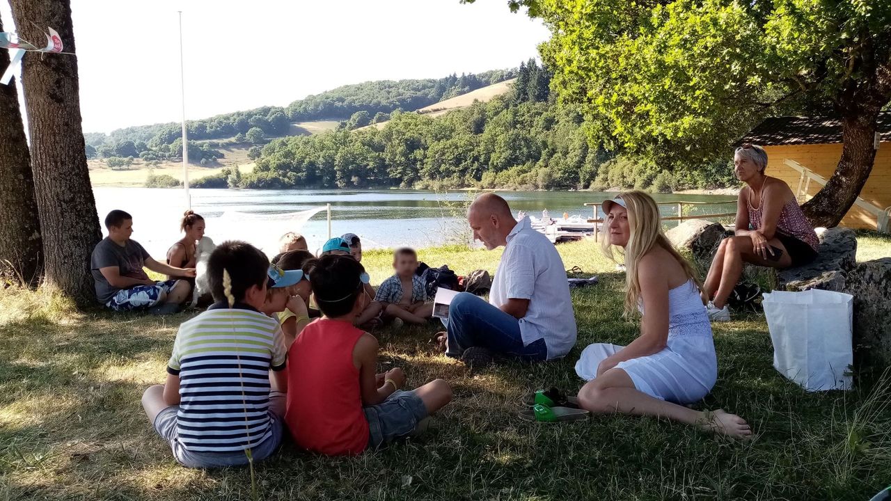 Reading by a lake in Aveyron