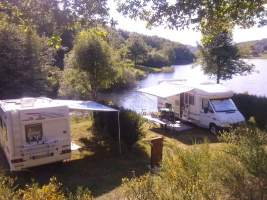 Camper van park area in aubrac by a lake in aveyron